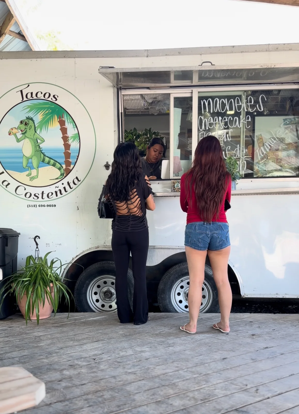 Customers ordering at the Tacos La Costeñita service window